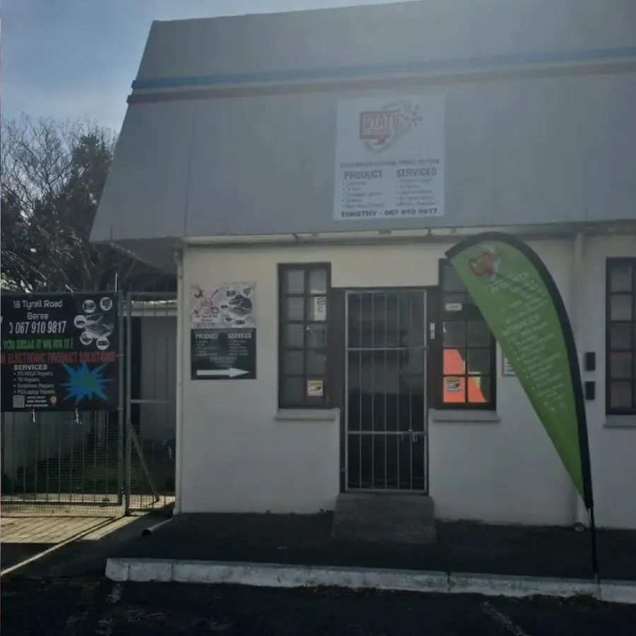The Static PC Repairs shop front at 18 Tyrell Road, with the sign above the door and the banner on the gate